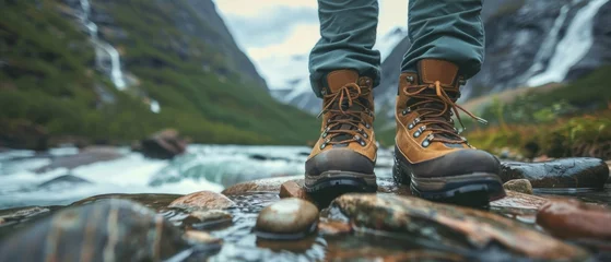 Foto op Aluminium View from mountains - Hiking hiker traveler landscape adventure nature outdoors sport background panorama - Close up of feets with hiking shoes from a man or woman walking in the river © Corri Seizinger
