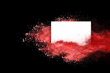 red powder explosion on empty round frame exploding on black background