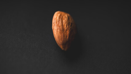 Close-up macro shot of an Almond on a black background.