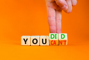 You can not or did it symbol. Concept word You did or You can not on beautiful wooden cubes. Beautiful orange background. Businessman hand. Business and you did or can not concept. Copy space.