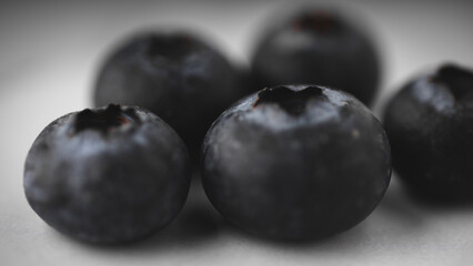 Close up macro shot of fresh blueberries on a white background.