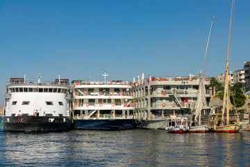 Several Nile river large cruise boats side by side at the dock in Aswan, Egypt - 753701110