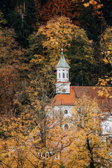 View of the church chapel on the mountainside amidst the fall forest