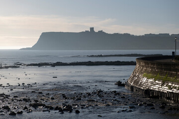 Scarborough Castle silhouetted with beach and ocean