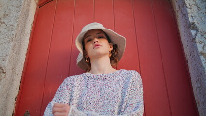 Casual girl posing street in old town portrait. Confident young female at door