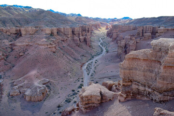 A mesmerizing view of the Charyn Canyon, the unusual shapes of red rocks resemble a valley of...