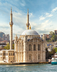 Fototapeta na wymiar View from Bosphorus Strait overlooking Ortakoy Mosque, or Ortakoy Camii, aka Buyuk Mecidiye Camii, suited at the waterside of the Ortakoy pier square, Istanbul, Turkey