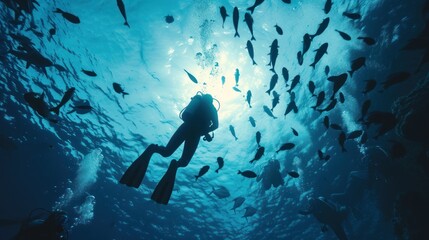 Diver descends into a deep blue underwater chasm, light piercing the depths