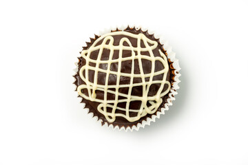 Chocolate muffin with white chocolate glaze isolated on white background. Top view.