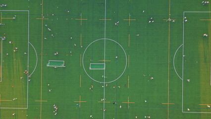 Top view green stadium under evening sunlight. Drone shot beautiful soccer field