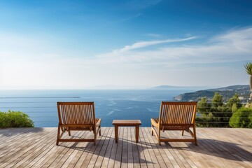 Naklejka premium Wooden deck chairs on the terrace of a luxury house with sea view, empty wood chair and table at the outdoor patio with beautiful tropical beach, Ai Generated