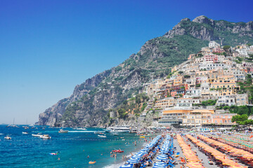 Thyrenian Sea and row of umbrellas on beach of Positano - famous old italian resort, Italy