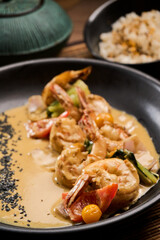 Shrimp scampi sauteed in butter and garlic with parsley sprinkled on top an rice