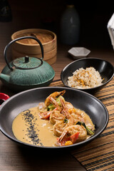 Shrimp scampi sauteed in butter and garlic with parsley sprinkled on top an rice