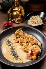 Shrimp scampi sauteed in butter and garlic with parsley sprinkled on top an rice