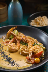 Shrimp scampi sauteed in butter and garlic with parsley sprinkled on top an rice