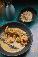 Shrimp scampi sauteed in butter and garlic with parsley sprinkled on top an rice