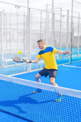 Open Tour template. Padel tennis player on the blue court background outdoors. Paddle tenis template for bookmaker design ads with copy space. Mockup for betting advertisement. Sports betting on tenis - 753732121