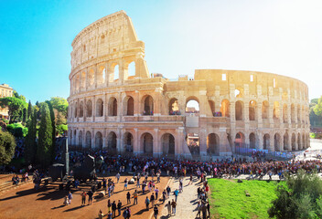 view of famous ruins of Colosseum with crowd of people in Rome with sunshine, Italy