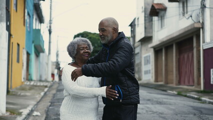 Loving Embrace of African American Son with Elderly Mother on City Street, Genuine Care Between 80s Senior and Her Caretaker