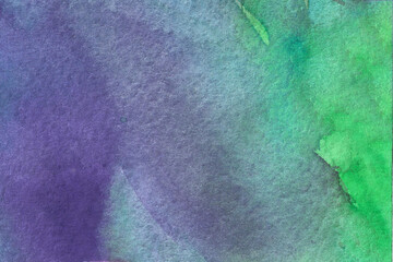 Hand painted watercolor textured multicolored background with spots,dots and splashes in blue violet green colors as design element.Abstract backdrop with copy space