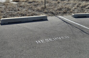 Parking space with a reserved sign painted on the asphalt 