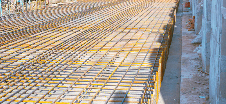 A construction site with a large metal grid on the ground - Powered by Adobe