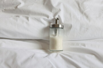 Sugar bowl on the bed and sugar is harmful to the human body. No food at night.
