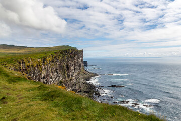 panoramic look over the steep cliffs to the coastline at puffin island, Iceland 