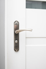 Interior door and one-way lock on it. Door handle made of steel. Stylish door handle.