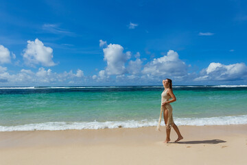 Fototapeta na wymiar Beautiful young woman on the background of the Bali island sea