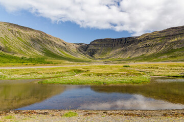 iconic panoramic Mountain View at Sauðlauksdalur next to the famous shipwreck in iceland. In front...