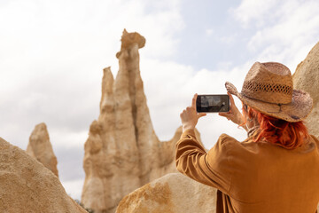Woman taking selfie, smiling, call us on phone, Woman with hat in nature brown clothes, adventures...