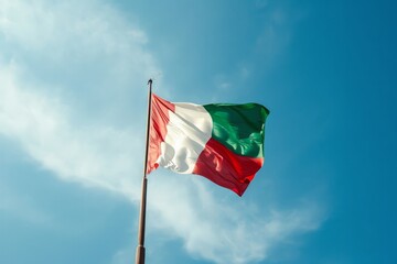 Naklejka na ściany i meble Large three colors Italian flag waving in the wind against sunny blue sky background