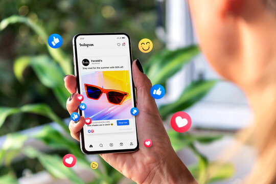 Meta ads on mobile phone screen. Woman holding smartphone showing advertising example on Instagram. Rosario, Argentina - March 06, 2024.