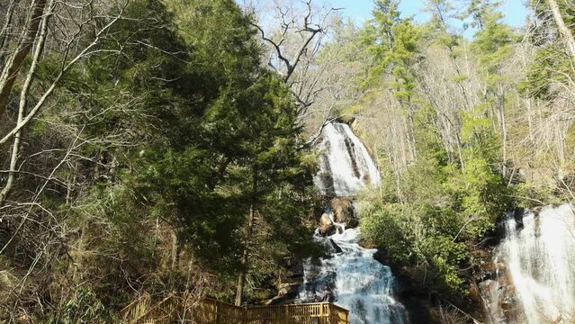 footage of the rushing water, rocks and waterfall at Anna Ruby Falls with lush green trees and plants in Helen Georgia USA