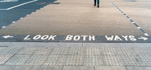 Look both ways written on a pedestrian crossing