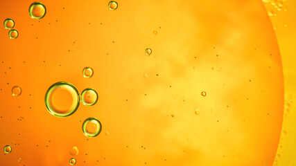 Abstract orange colorful background with oil on water surface. Oil drops in water abstract...