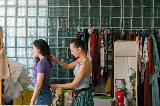 seamstress measures a girl's body parameters