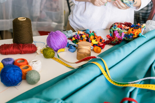 seamstress hands select threads