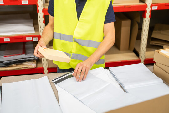 Anonymous Logistic Worker Packing Parcel Indoors
