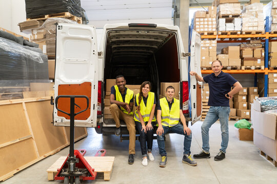 Warehouse Workers And Driver In Front Of The Van