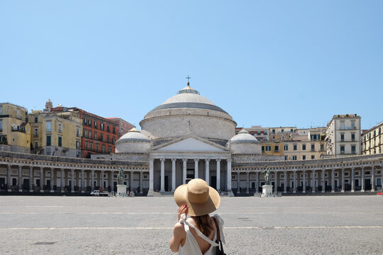 Portrait of a female tourist with hat from behind in Naples
