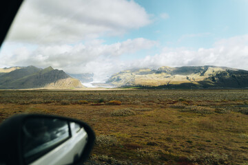 Moss-covered lava fields, snowy mountain peaks and farm houses