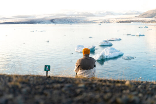 hiker enjoys glacier lagoon view, free from crowd near restricted area
