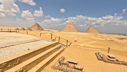 Landscape with three pyramids under blue sky. Landscape view at the Pyramids of Giza and Cairo....