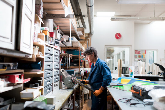 Mature woman working at small business workshop