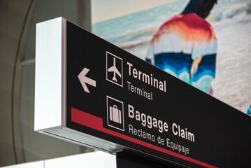 "Terminal and Baggage Claim" sign on black color with the information on white color