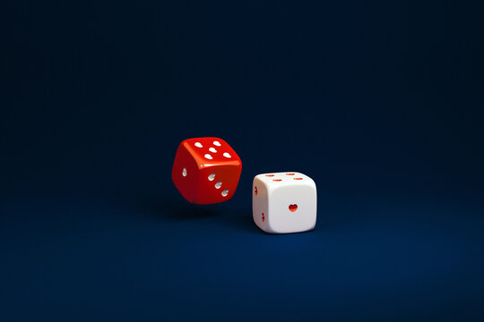 White and red dice with red heart-shaped dots