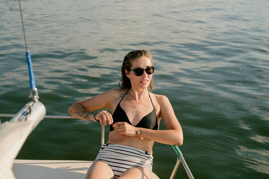 Young Woman Enjoying Summer Time on a Sailboat